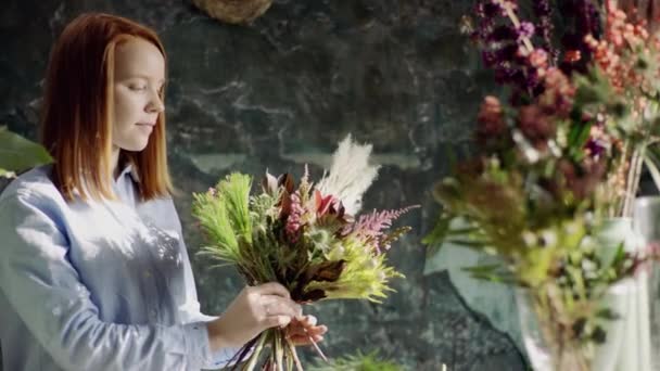 Florista de gengibre arranjando flores em bouqet — Vídeo de Stock