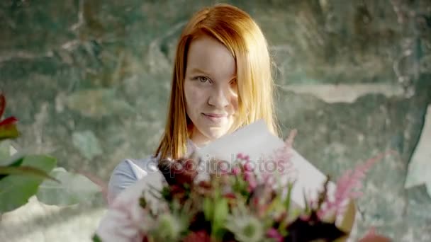 Schöne Blumenhändlerin gibt Blumenstrauß — Stockvideo