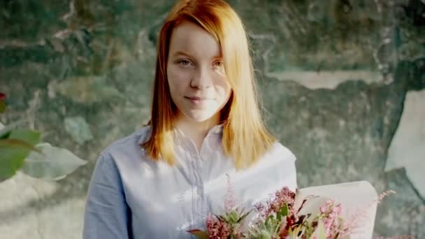 Мила молода жінка дивиться на квіти гнів даючи йому — стокове відео