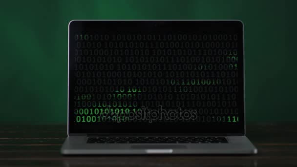Binary code at laptop standing at the desk — Stock Video