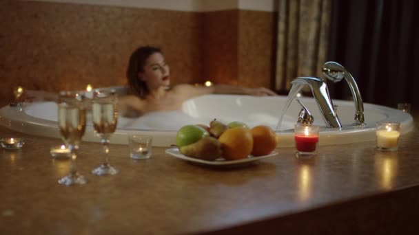 Sexig ung kvinna kopplar av i jacuzzin med skum — Stockvideo