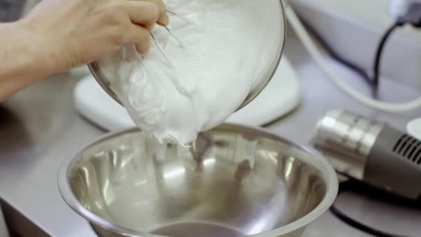 Vrouw hand giet crème uit één pan in een andere — Stockvideo