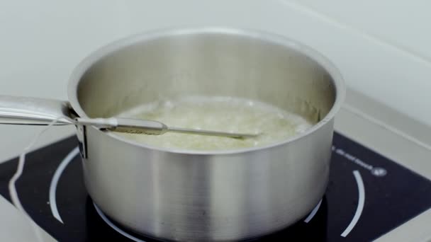 Boiling sugar syrup in the silver bowl — Stock Video