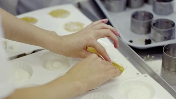 Женские руки кладут торт в специальную выпечку — стоковое видео