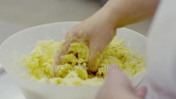 Womans hand kneads the shortcake dough — Stock Video