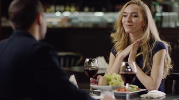 Smiling cute lady sitting at the table with a man — Stock Video