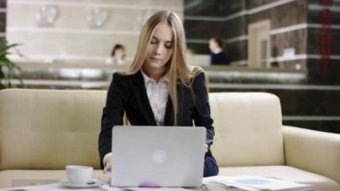 laptop ve kağıt belgeleri ile çalışan kadın