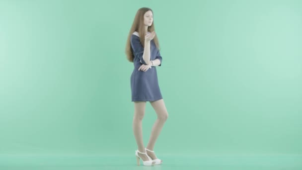 Uma menina bonita no vestido fica pensando em voz alta — Vídeo de Stock