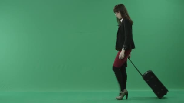 Young woman walking with a wheeled suitcase — Stock Video