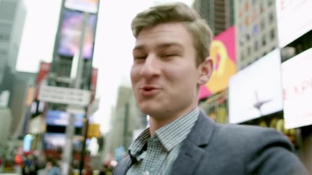 Young man is shooting himself and rotating around on Times Square — Stock Video