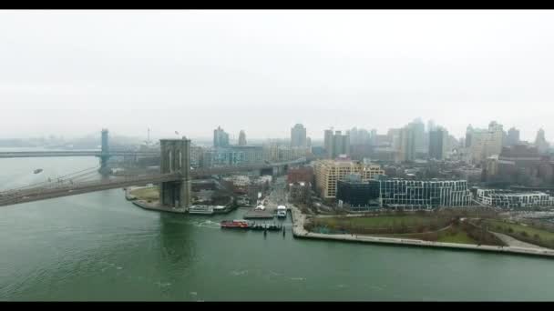 Antenn skott över Brooklyn bridge och Brooklyn park och Hudsonfloden med båtar på den — Stockvideo