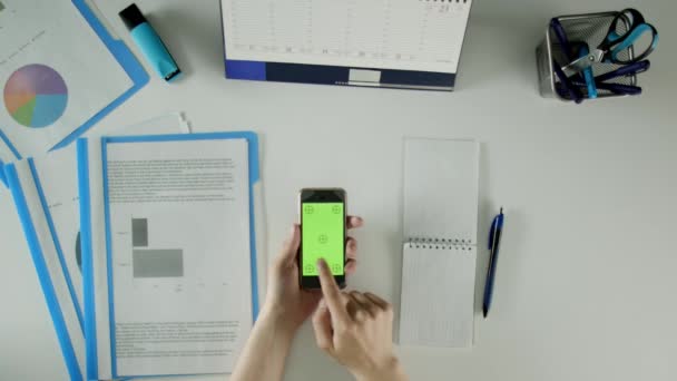 A man works, uses his phone and checking information from documents. — Stock Video