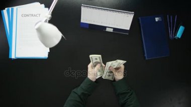 Bir adam bir ofis masa başında oturan ve bir telefon kullanma.