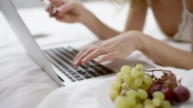 Muhteşem kadın yatağında onu laptop ve kredi kartı kullanarak alışveriş online