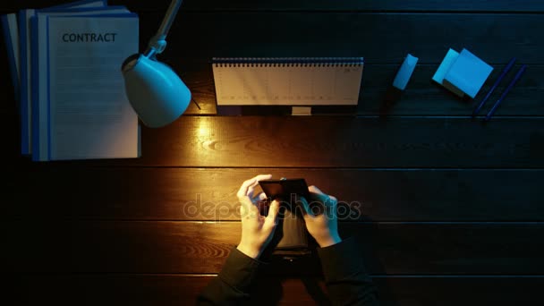 Ein Mann sitzt an einem Schreibtisch im Büro und telefoniert. — Stockvideo