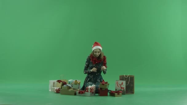 Young cheerful woman got a good Christmas present, chroma key on background — Stock Video