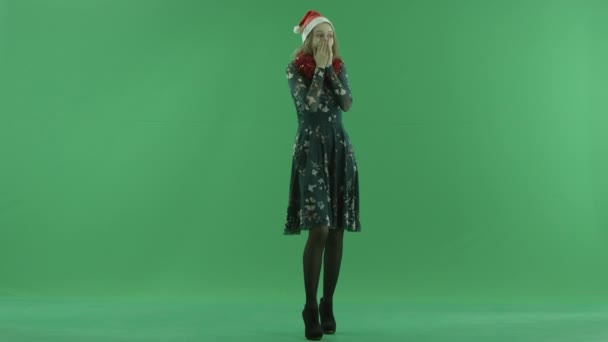 Happy amazed young woman in Christmas hat laughs, chroma key on background — Stock Video