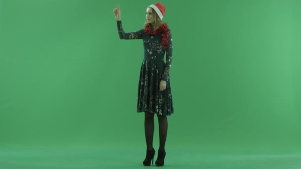 Young attractive woman in Christmas hat using ar screen, chroma key on background — Stock Video