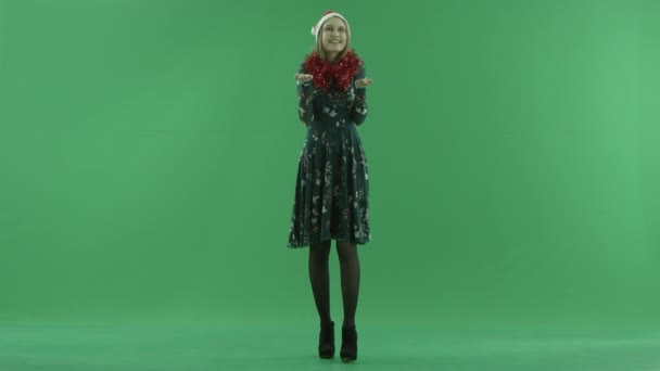 Young woman in Christmas hat catching snowflakes, chroma key on background — Stock Video