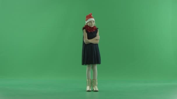 Poor little girl freezes and tries to kepp warm, chroma key on background — Stock Video