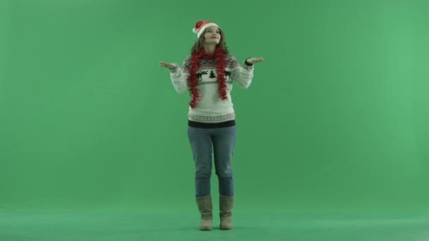 Attractive young woman in Christmas hat enjoys of snowfall, chroma key on background — Stok video