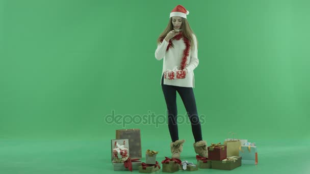 Uroczy młoda kobieta w Boże Narodzenie kapelusz ma zdjęcie jej prezent, Kluczowanie na tle — Wideo stockowe