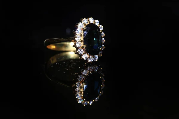 Jewellery diamond ring and gemstone on a black background — Stock Photo, Image