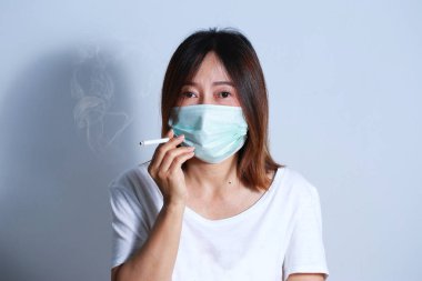  Genç kadın sigara Sigara İçilmeyen kavramı koruyucu maske ile durdurmak