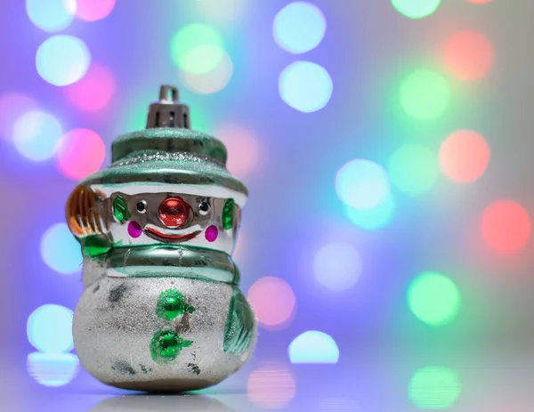 Retro brinquedo de Natal boneco de neve no fundo bokeh . — Fotografia de Stock