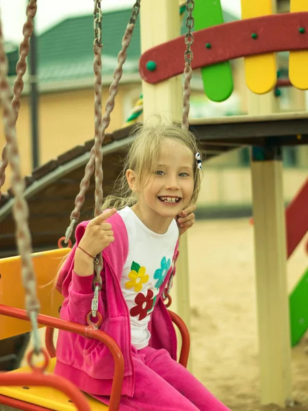 Girl fun riding on the swings in the gaming system.