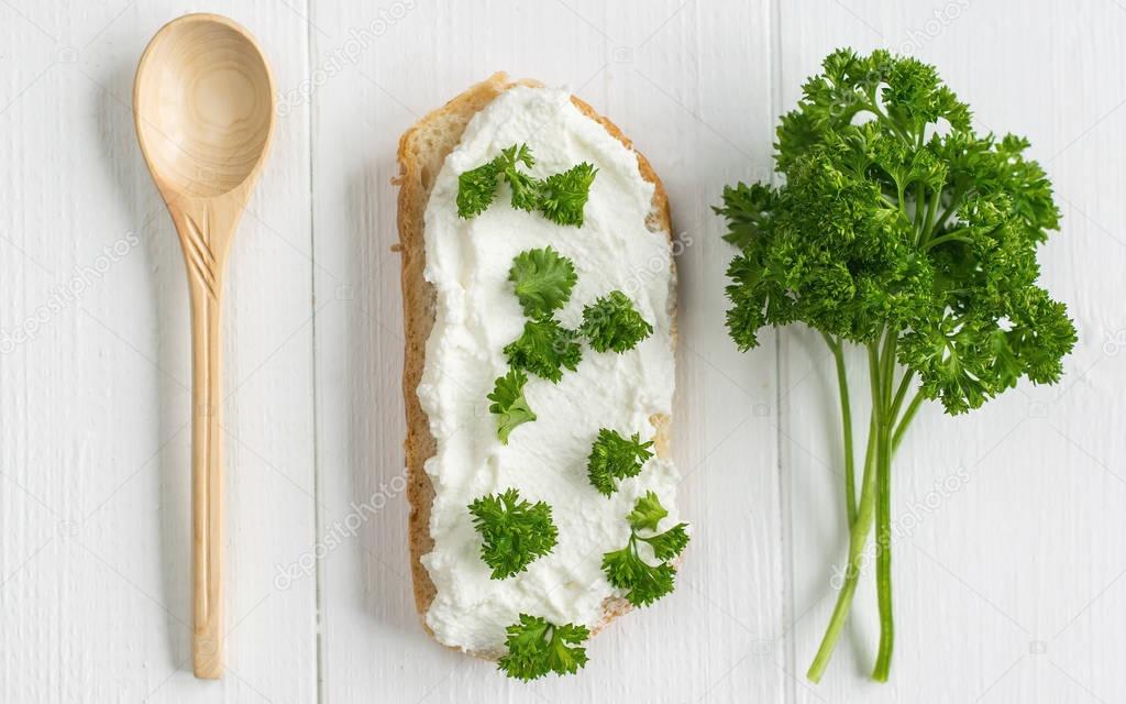 Conceptual image fresh cream cheese with herbs.