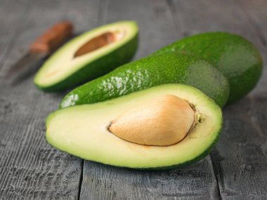 Ahşap rustik masa üzerinde olgunlaşmış avokado.