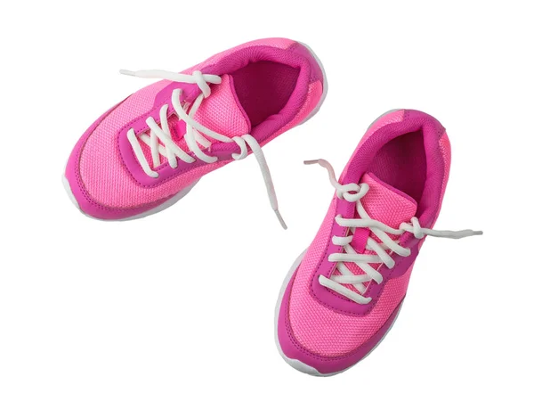 Kvinnors rosa sneakers med obundet vita skosnören isolerad på vit bakgrund. — Stockfoto