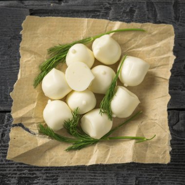 Taze mozzarella peyniri dereotu ile ahşap bir masa üzerinde yapılmış. Seçici odak. Üstten Görünüm.