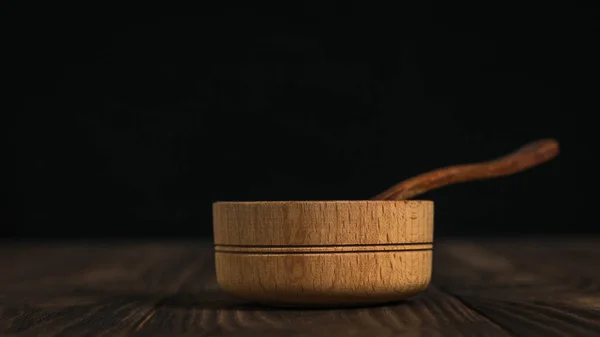 Cuchara de madera y copa de madera sobre una mesa de madera oscura . — Foto de Stock