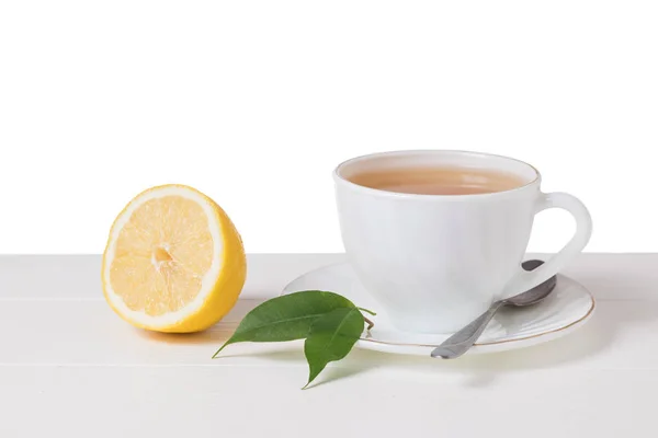 Fresh green tea with lemon in a white bowl on a white table isolated on a white background. — Stock Photo, Image