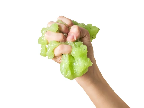 A child's hand crushes a green lime isolated on a white background. — Stock Photo, Image
