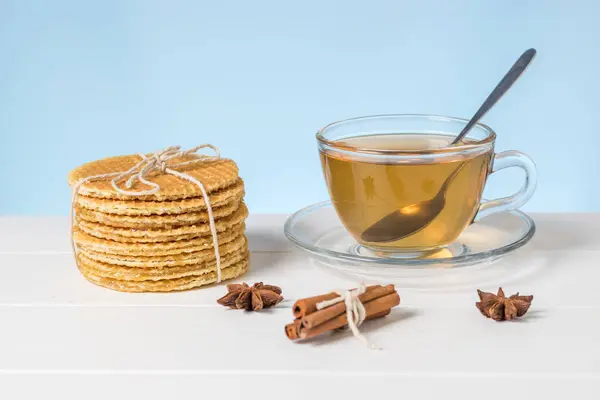 Gofres caseros y té en un vaso Copa sobre una mesa blanca sobre un fondo azul . — Foto de Stock