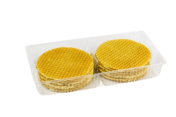 Round wafers with caramel cream in a plastic container isolated on a white background. — Stock Photo, Image