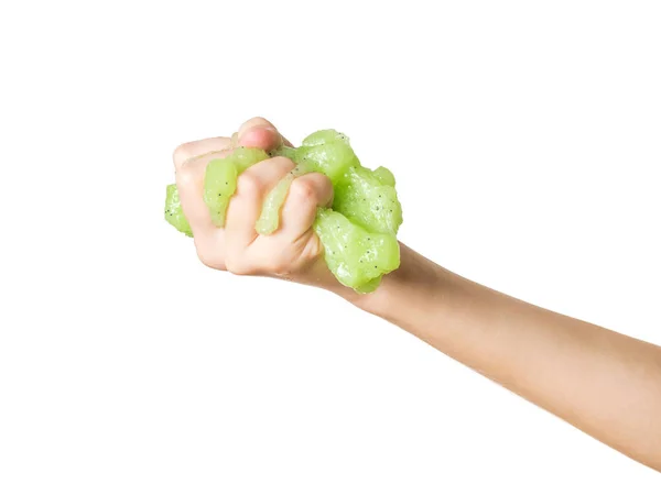 Hand with a large green slime with black splashes isolated on a white background. — Stock Fotó