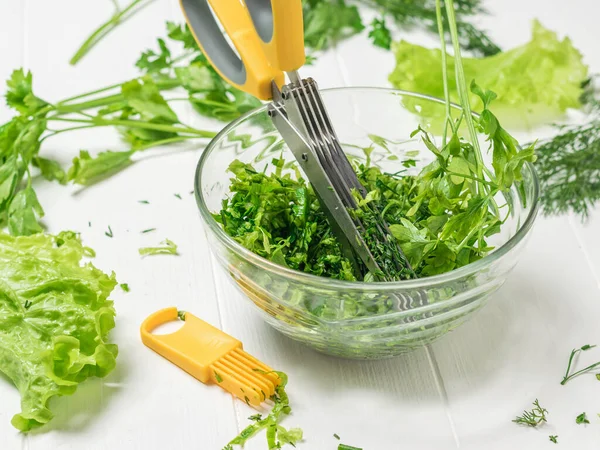 Tesoura de cozinha amarela e ferramentas de limpeza com uma tigela de salada . — Fotografia de Stock