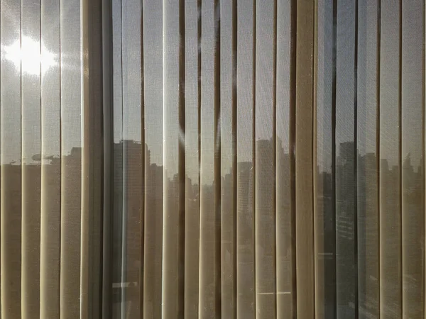 Beige vertical blinds with city background — Stock Photo, Image