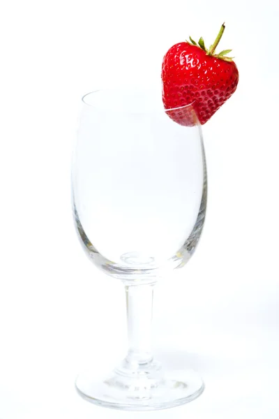 Red and ripe strawberry in wineglass on a white background — Stock Photo, Image