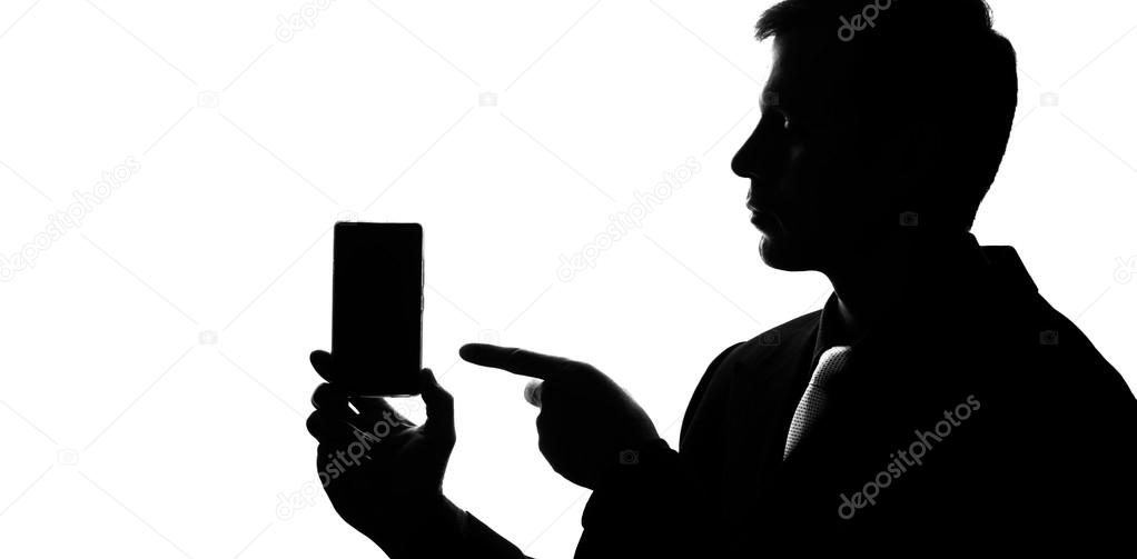 Young man in suit and tie point on smartphone