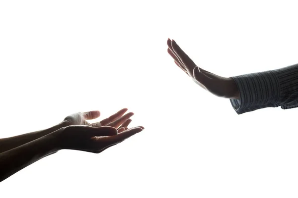 Vrouwen hand uitgerekt met alms tegenover de weigering - silhouet — Stockfoto