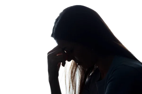 Silhouette of a young woman keep her head Stock Photo