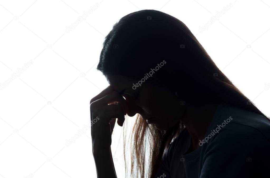 Silhouette of a young woman keep her head