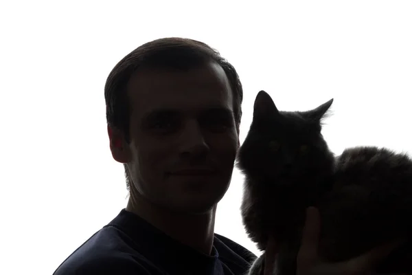 A young man with a kitten in his hands — Stock Photo, Image