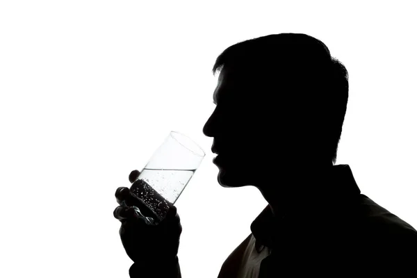 Young man drinks soda water - silhouette Stock Picture