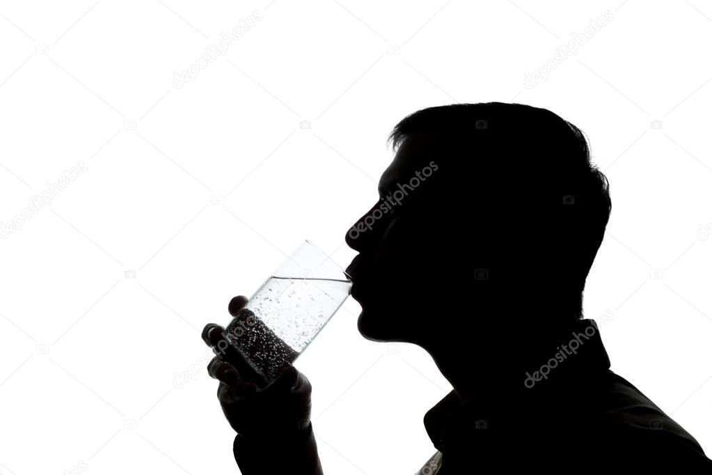 Young man drinks soda water - silhouette
